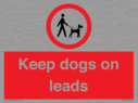 dogs-on-lead-symbol-with-black-text-on-white-background~